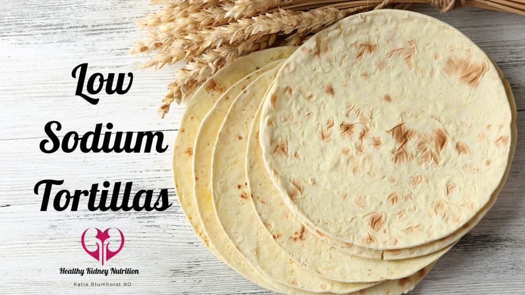 Stack of homemade flour tortillas on a wooden table.